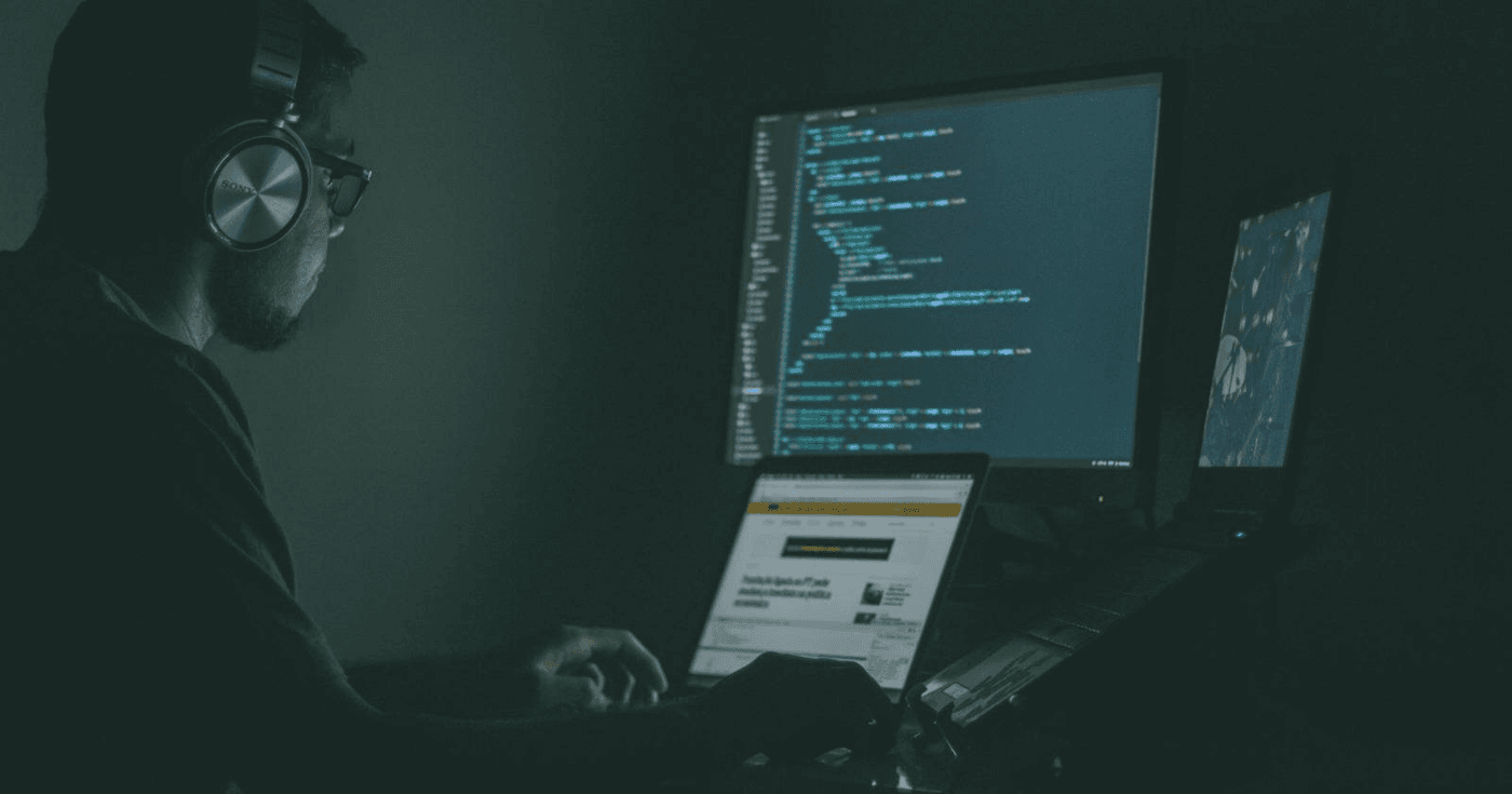 Photo of a programmer writing code on a dark screen, illustrating the Claude Code gateway key leak story