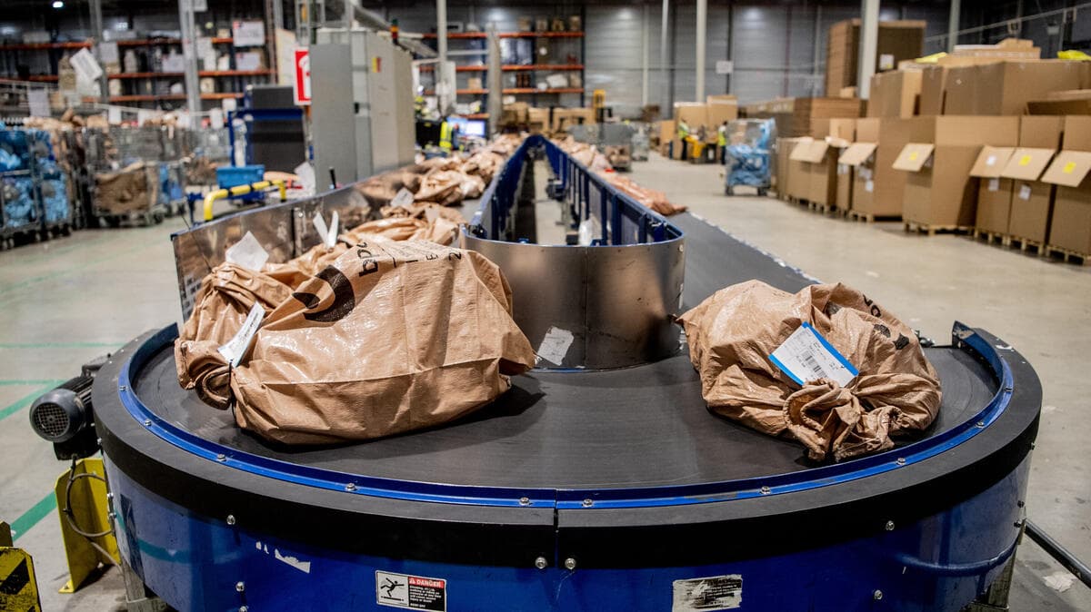Packages queued on a conveyor belt waiting to be processed, symbolizing a background job queue