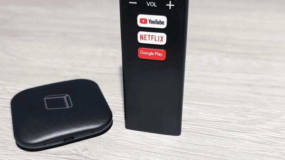 Photo of a black Android TV box with remote, illustrating cheap IoT devices capable of hosting AI model inference