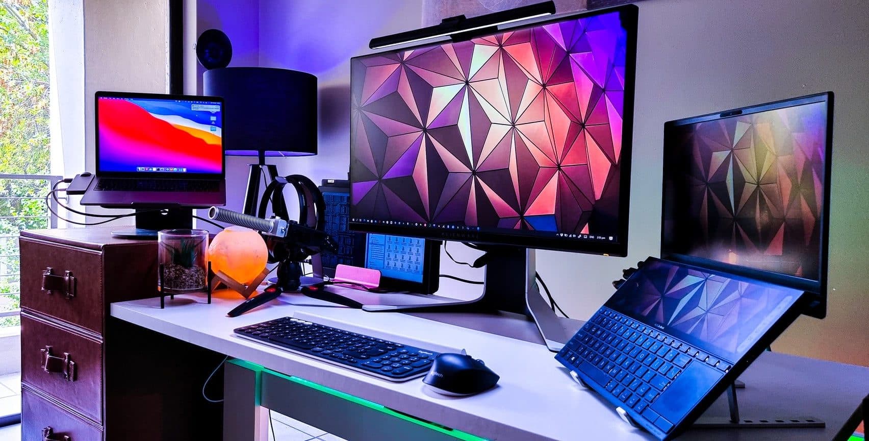Multi-monitor desk setup with laptops, illustrating the solo portfolio operations guide for indie developers (October 2026)