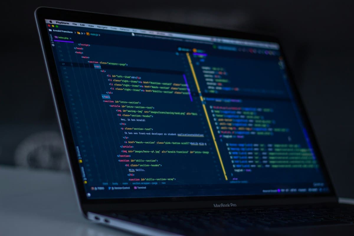 A real photograph of code on a laptop screen, not a screenshot of Cursor or the Agent SDK interface