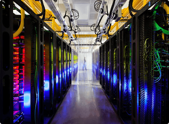 Real photo of a cloud data center with rows of illuminated server racks