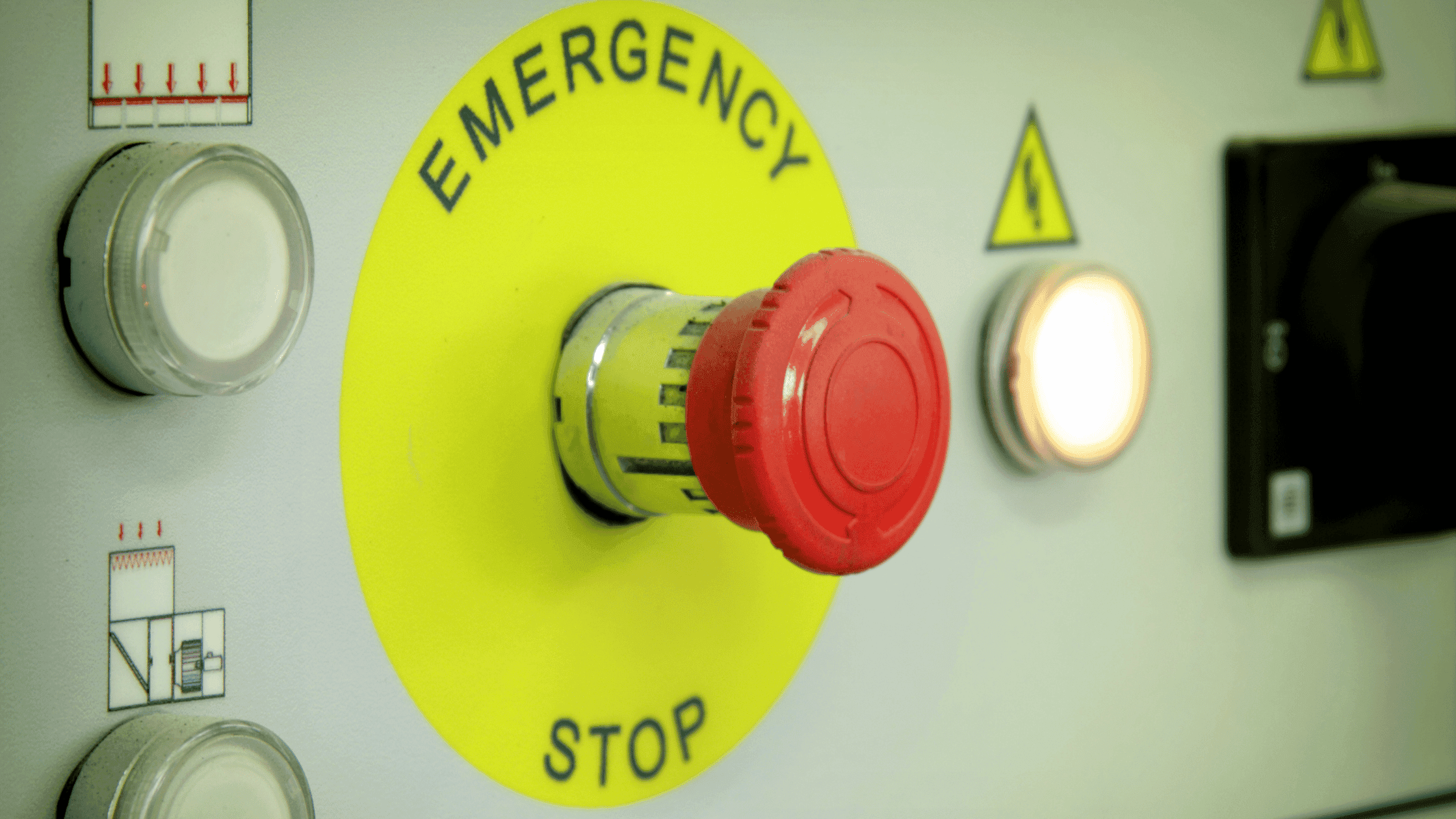 Real photo of an industrial emergency stop button on a control panel