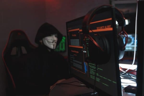 Photo of a security researcher at work, with bug bounty related content on the computer screen