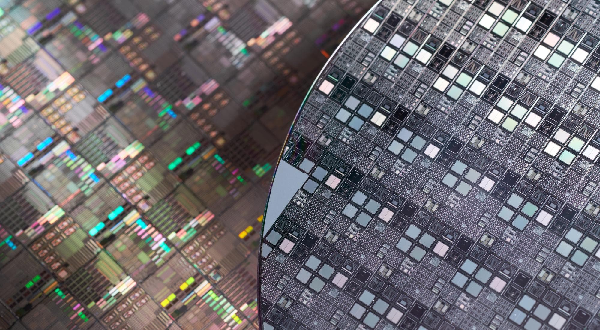 Silicon wafers in a semiconductor fab, illustrating Tenstorrent's $1.5B Series E bet on open-weight AI inference chips (October 2026)