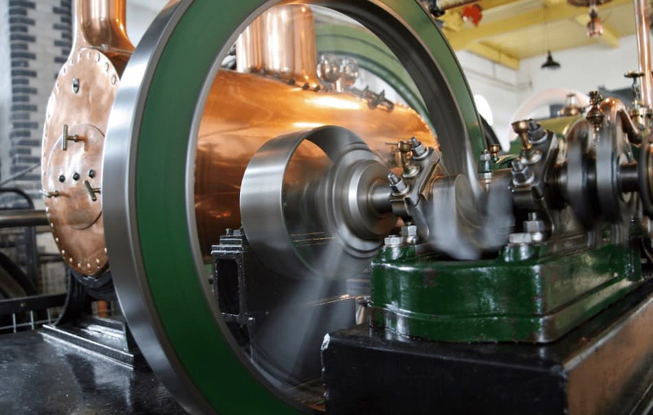 Close-up photograph of a large industrial flywheel in motion, a visual metaphor for the data flywheel