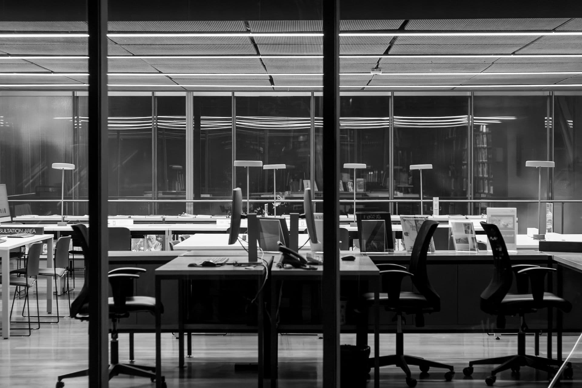 An empty office at night with the lights off — symbolizing a project's shutdown and postmortem