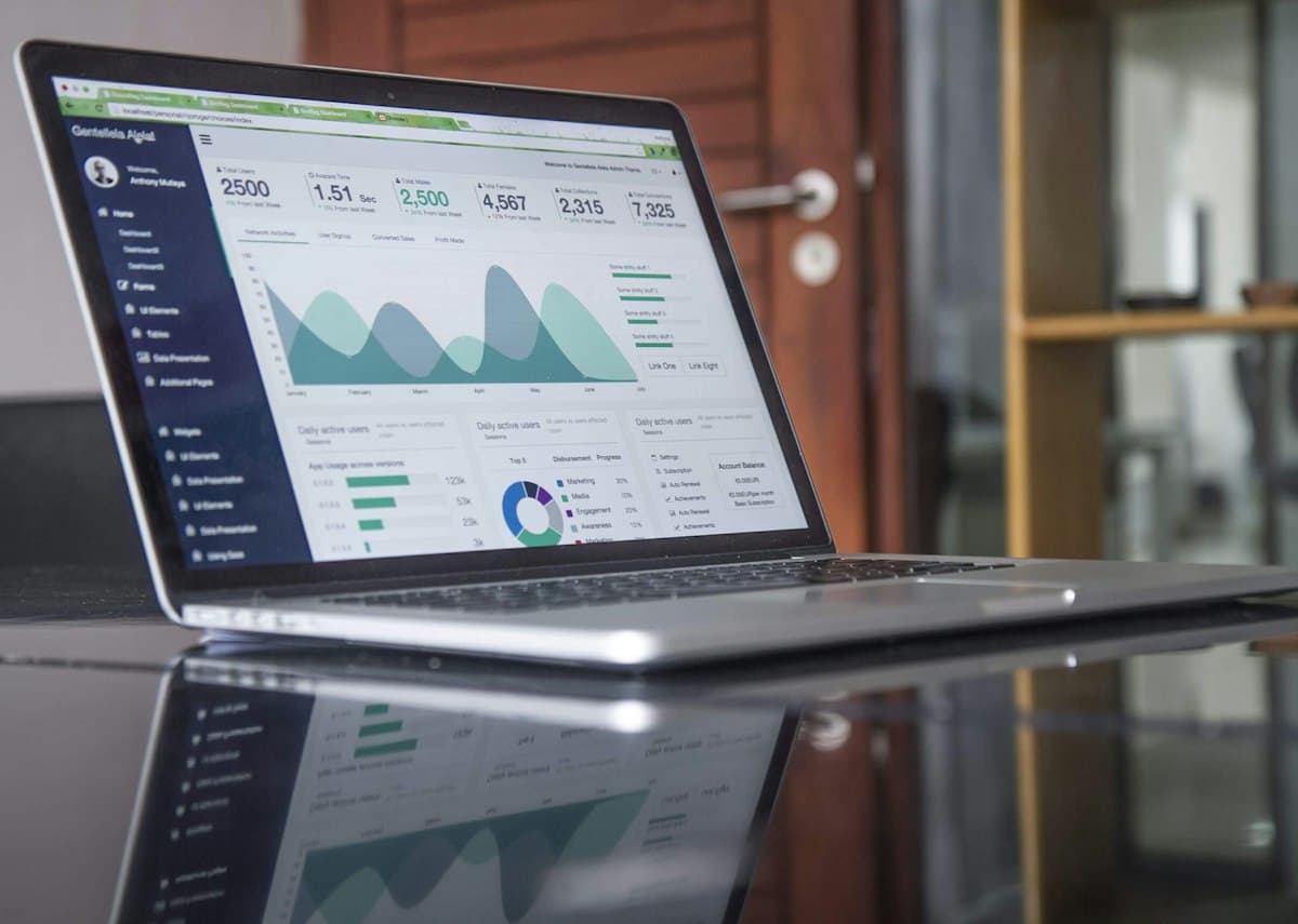 A real photograph of a laptop showing a data dashboard, not a screenshot of any product's bulk-action interface