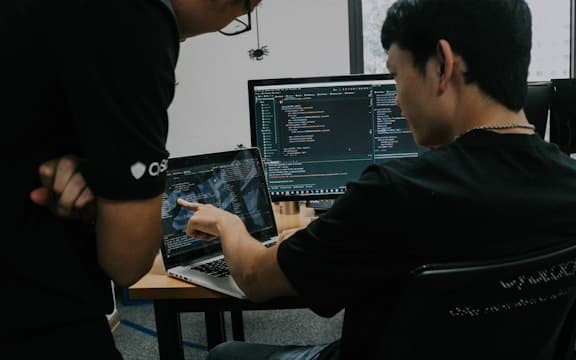 Two developers reviewing code together, open-source collaboration photo