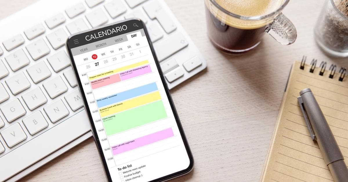 Cover: a real photo of a smartphone showing a calendar app's day view next to a keyboard, coffee cup, and notepad
