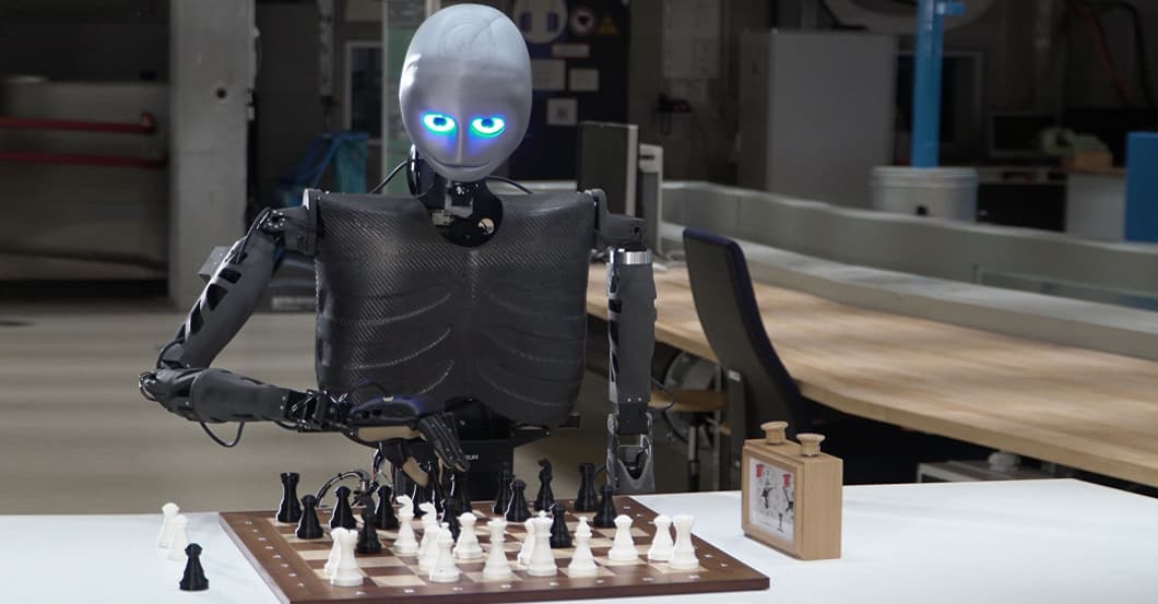 Real photo of a humanoid robot playing chess in a laboratory (illustrative image, not an official Genie 4 or Apollo demo still)