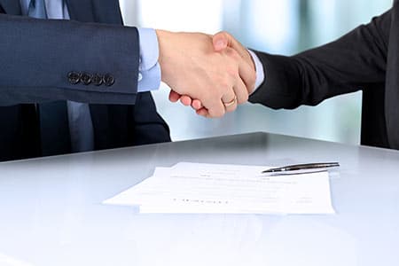 Contract signing with pen and handshake, illustrating the freelance contract playbook for vibe projects (October 2026)