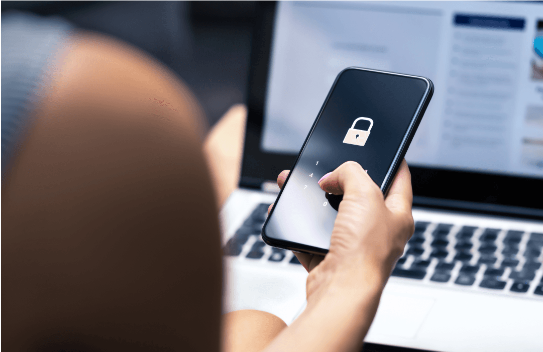 A hand holding a phone showing a lock icon and PIN keypad, illustrating ChatGPT's Locked Chats feature