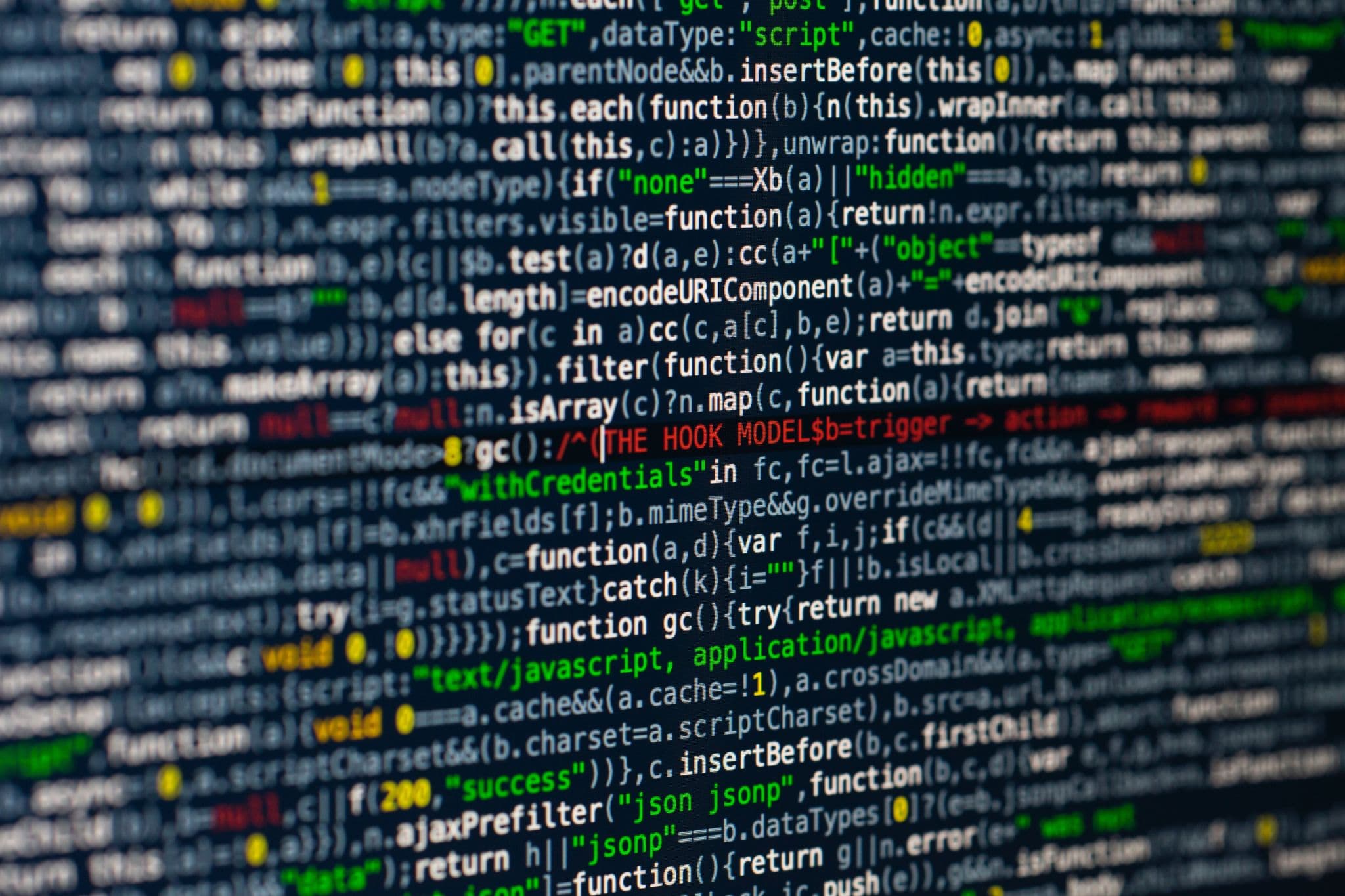 深色屏幕上 JavaScript 代码的特写实拍,象征需要在关停日期前迁移的模型 ID 与 API 代码。
