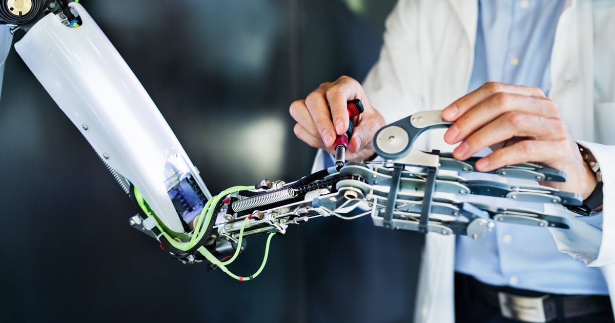 An engineer fine-tuning a robotic hand mechanism