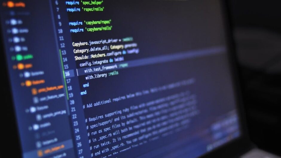 Real photo: close-up of code on a screen in a dark environment