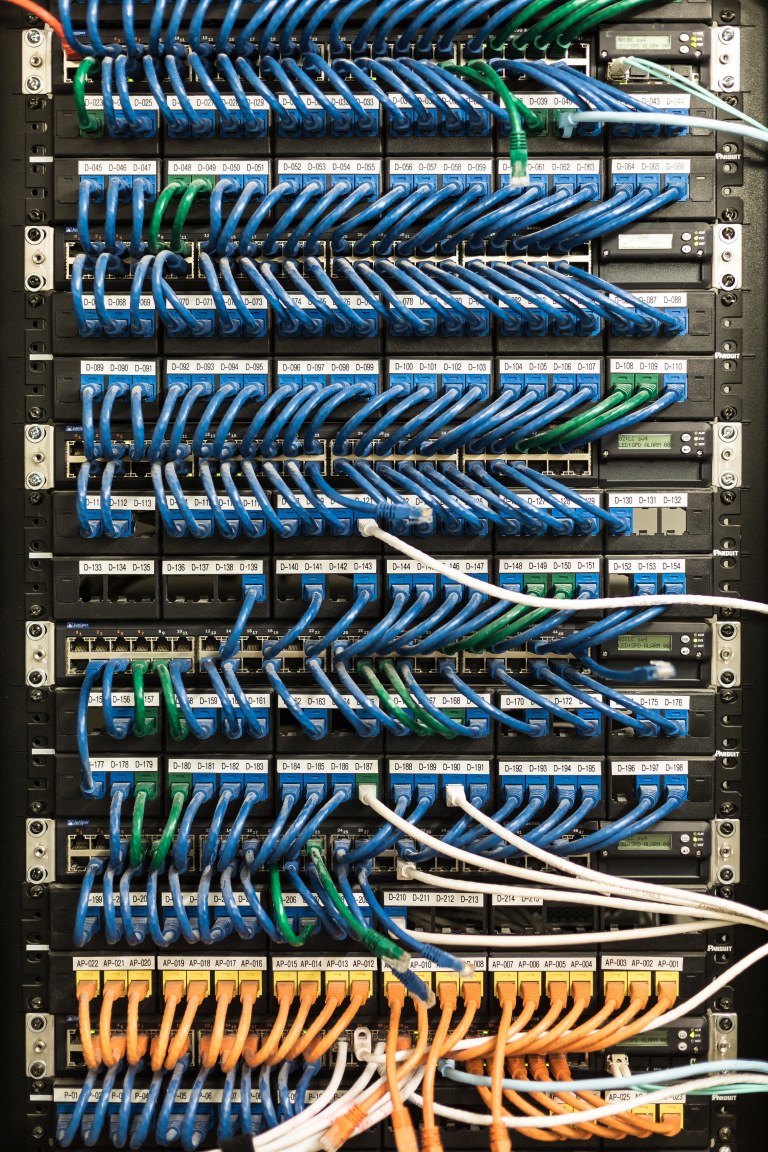 Tangled cables in a server room, symbolizing intertwined third-party dependencies in an application