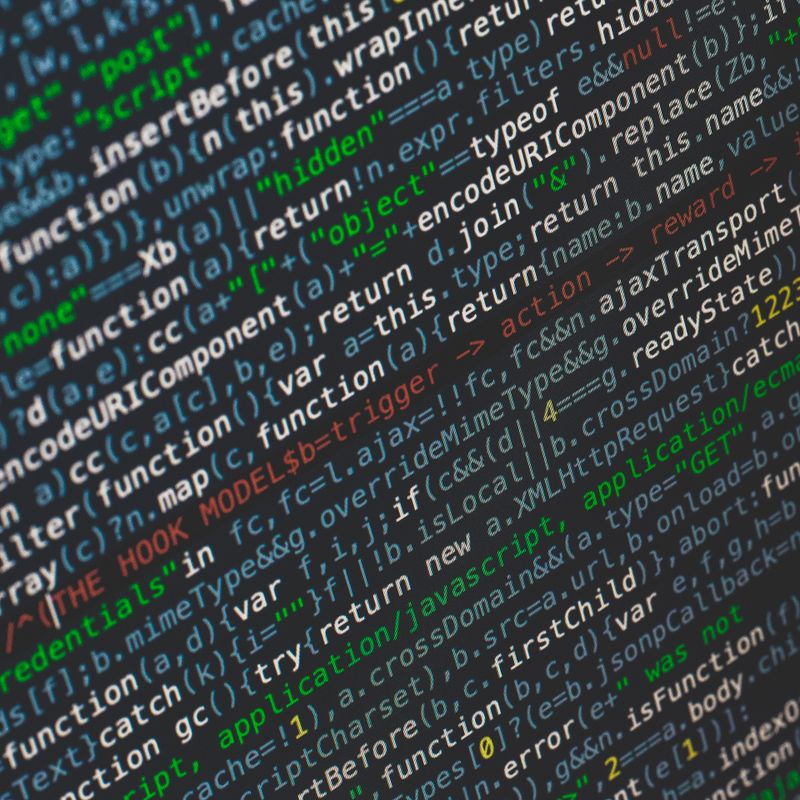 Close-up of code: minified JavaScript on a dark background