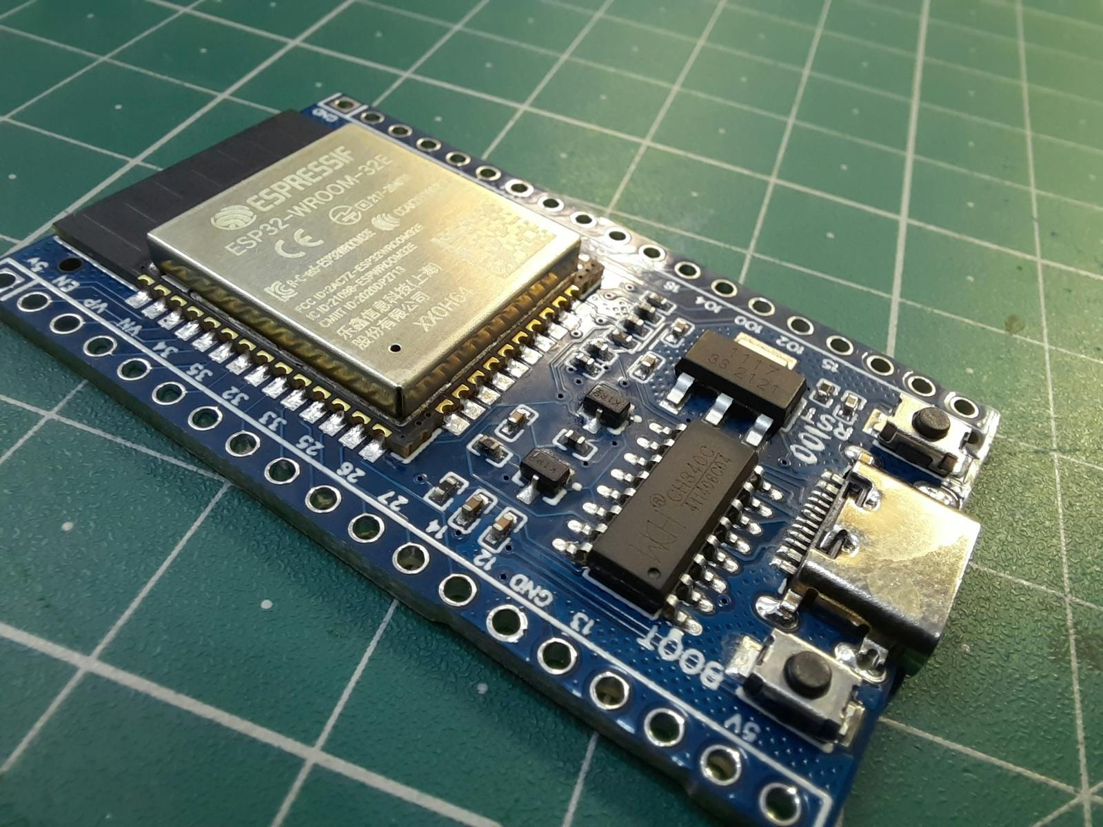 Close-up of an ESP32 dev board with visible chip and pin headers, symbolizing DIY hardware