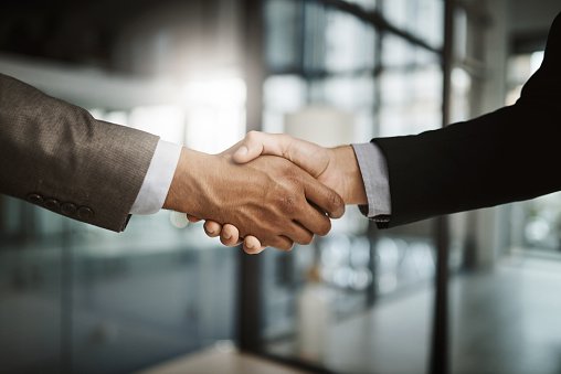 A business handshake in a modern office